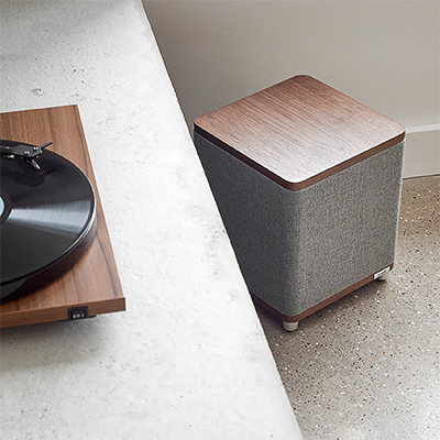 Caisson de basses Ruark Audio RS1 montrant le tissu acoustique et le bois de noyer